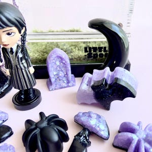 Close-up of magnetic crescent moon hide, crystals and handmade gothic spider enclosure décor.