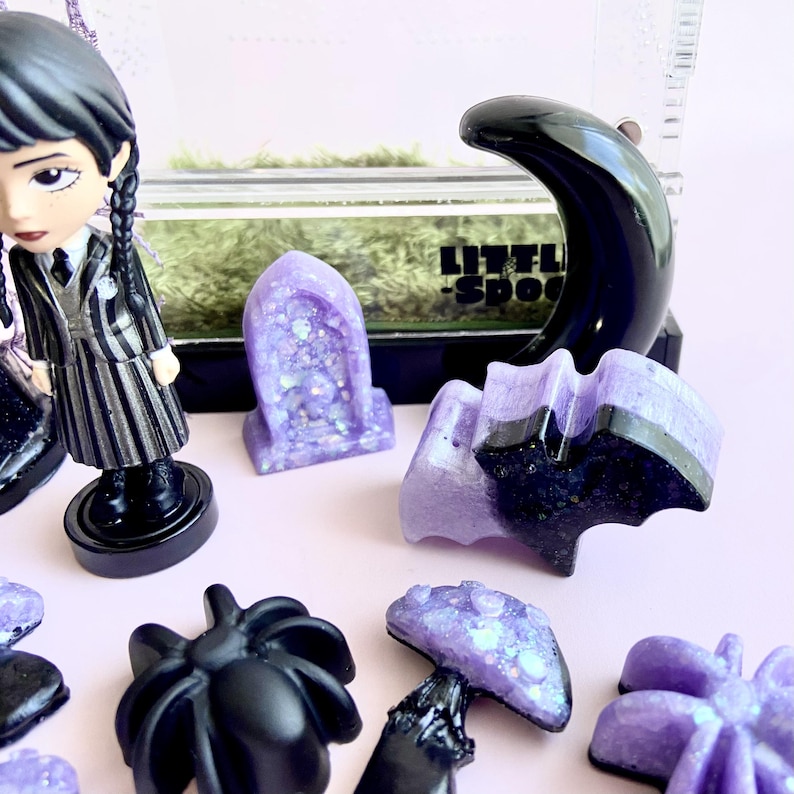 Close-up of magnetic crescent moon hide, crystals and handmade gothic spider enclosure décor.