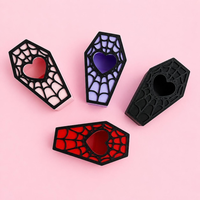 Magnetic jumping spider coffin hides available in pink, purple, black, and red color options.
