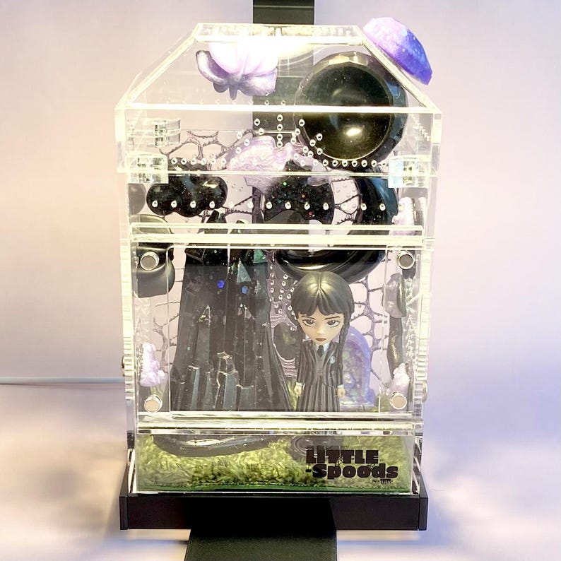 Wednesday Addams themed jumping spider enclosure glowing under optional Lumi light.