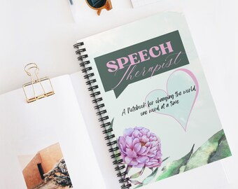 May include: A spiral bound notebook with a green and white cover. The cover has the text "SPEECH Therapist" in a speech bubble and the text "A Notebook for changing the world one word at a time" in a pink heart. The cover also features a watercolor illustration of a pink peony.