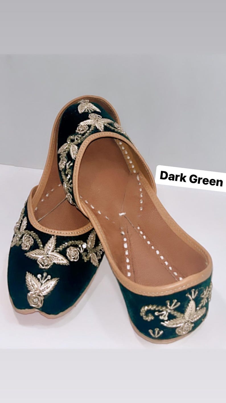 May include: A pair of dark green velvet shoes with gold embroidery. The shoes have a pointed toe and a low heel. The text "Dark Green" is visible in the image.