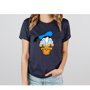 a woman wearing a donald duck t - shirt