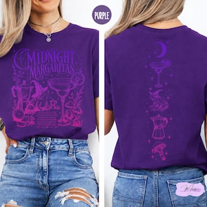 a woman wearing a purple t-shirt with a graphic design of a margarita on it.