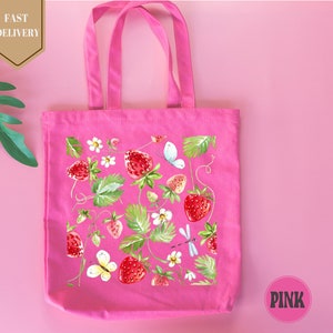 a pink bag with strawberries and flowers on it