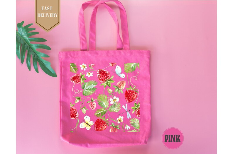 a pink bag with strawberries and flowers on it