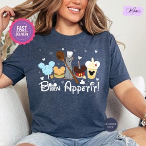 a woman sitting on a couch wearing a t - shirt that says bon apperi