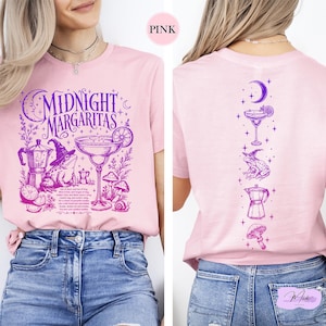 A woman wearing a pink t-shirt with a graphic design of a margarita on it.