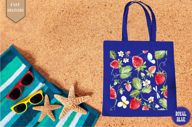 a blue shopping bag sitting on top of a sandy beach