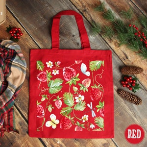 a red shopping bag sitting on top of a wooden floor