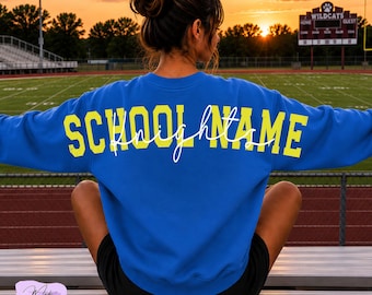 May include: A bright blue long-sleeve crewneck sweatshirt featuring the text SCHOOL NAME in bold yellow block letters across the back, with the word Knights written in a white cursive script layered over the yellow text.