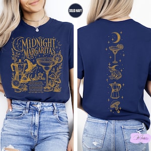 a woman wearing a navy blue t-shirt with a graphic design on the front and back.