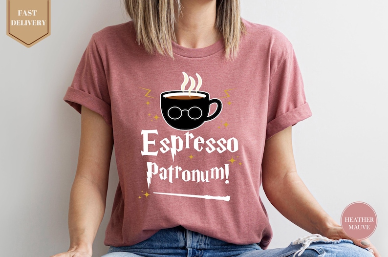 a woman wearing a pink shirt that says espresso patronum