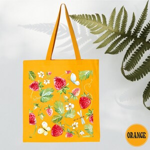 a yellow tote bag with flowers and leaves on it