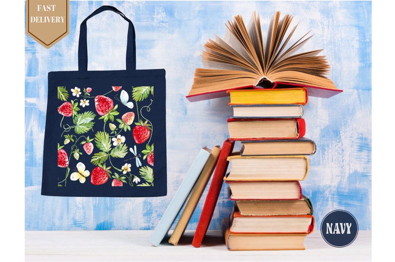 a stack of books and a tote bag next to a stack of books