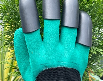Op de afbeelding: Groene tuinhandschoenen met zwarte vingertopbeschermers. De handschoenen hebben een zwarte polsband.