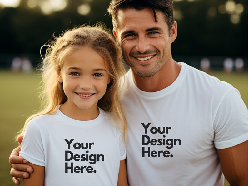 May include: A father and daughter wearing white t-shirts with the text "Your Design Here." printed on them. They are smiling and looking at the camera.