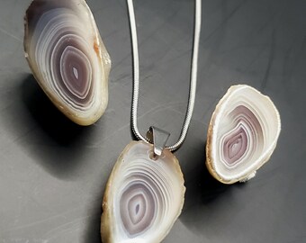 Polished Botswana Agate pair, with matching raw edge pendant, cut from the same rock.