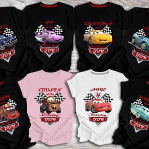 May include: Set of ten black, white and pink t-shirts with a Cars theme. Each shirt features a different character from the Cars movie, including Lightning McQueen, Mater and Tow Mater. The shirts also include the text "Birthday Boy" and the phrase "of the".