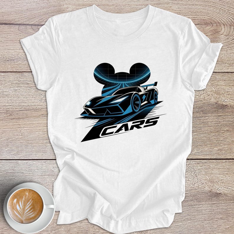 May include: White t-shirt with a black and blue graphic of a race car and the word "CARS". The design includes a stylized Mickey Mouse head silhouette above the car.