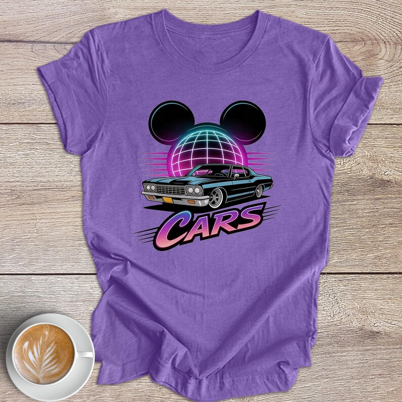 May include: A lilac t-shirt with a retro car graphic. The design features a black car, a neon grid, and the word "CARS" in a colourful font. The design also includes Mickey Mouse ears.