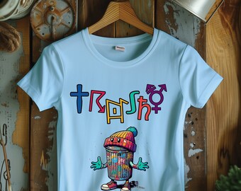 May include: Light blue t-shirt with a colorful graphic of a trash can wearing a hat and the word "Trash" with a gender symbol.