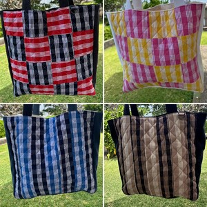 May include: A collection of four quilted tote bags featuring various plaid patterns. The bags include red and black, yellow and pink, blue and black, and tan and black color combinations. Each tote has black side panels and two black shoulder straps.