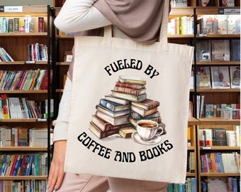 May include: A beige tote bag with the text "Fueled by Coffee and Books" printed on it. The bag features a stack of books and a cup of coffee.