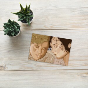 May include: A close-up of two people looking at each other. The person on the left has blonde hair and is wearing a light brown shirt. The person on the right has dark hair and is wearing a light brown shirt.