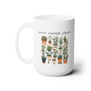 以下が含まれることがあります： 白いセラミック製のマグカップで、黒いグラフィックに「never. enough. plants.」と書いてあり、鉢植えの植物のカラフルなイラストが描かれています。