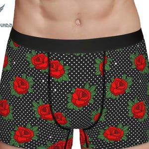 May include: Black boxer shorts with a white polka dot pattern and red roses.