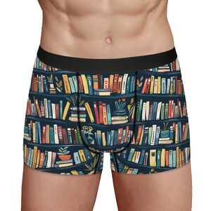 May include: Boxer briefs with a navy blue background and a colorful bookshelf pattern. The design features rows of books in various colors, with potted plants interspersed throughout. The waistband is black.
