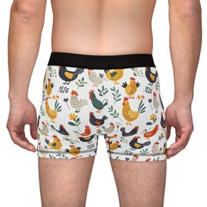 May include: White boxer briefs with a colorful pattern of chickens and flowers.