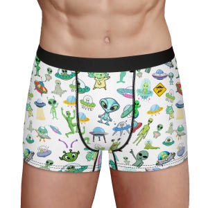 May include: White boxer briefs with a green, black, and white alien pattern. The pattern includes aliens, spaceships, and planets.