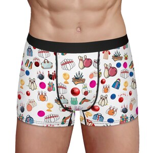 May include: White boxer briefs with a bowling-themed print. The print features bowling pins, bowling balls, bowling bags, and the word "Bowling" in a red banner.