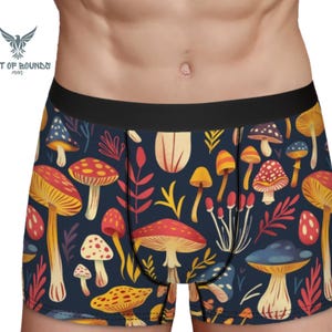 May include: Blue boxer shorts with a colorful mushroom and leaf pattern.