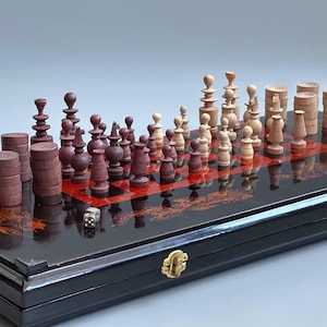 May include: A black lacquered game board featuring a red and black grid with gold dragon illustrations. The set includes dark purple and light natural wood game pieces, including stacked circular tokens, carved chess-like figures, and two small dice.