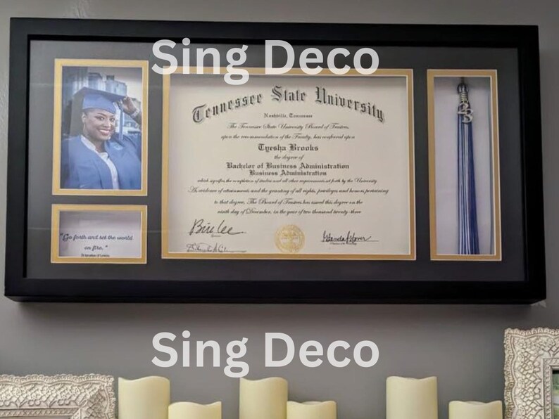 May include: A black framed diploma shadow box with a gold mat. The diploma is from Tennessee State University and is for Eyesha Brooks. The diploma is for a Bachelor of Business Administration. The shadow box also includes a photo of the graduate and a graduation tassel.