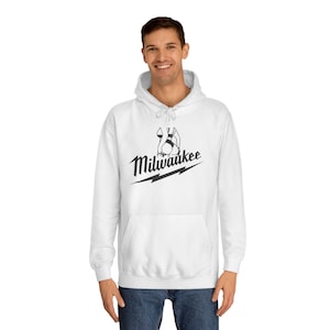 May include: White hooded sweatshirt with a black graphic of a logo and the word "Milwaukee" in a script font. The logo is above a lightning bolt design.
