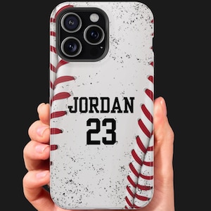 May include: White iPhone case with a baseball design. The case has red stitching and the text "JORDAN 23" printed on it.