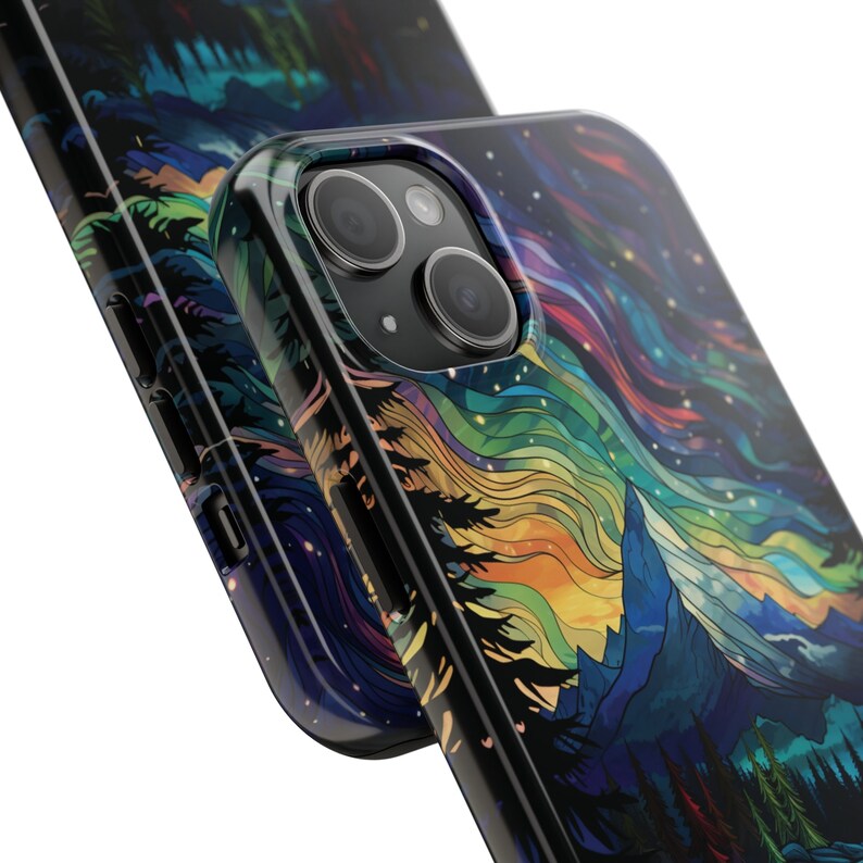 May include: A black phone case with a colorful abstract design of a mountain range and a starry sky. The case has a cutout for the phone's camera.