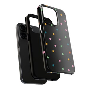 May include: A black phone case with a colourful polka dot pattern. The case is made of a hard plastic material and has a raised lip around the camera lens to protect it from scratches.