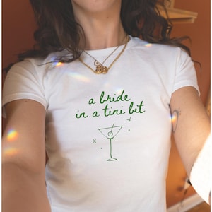 A Bride In A Tini Bit Baby Tee Dirty Martini Themed Bachelorette Party Dirty Martini Bride Baby Tee Dirty Martini Bachelorette Martini Bach