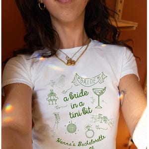 A Bride In A Tini Bit Baby Tee Custom Dirty Martini Themed Bachelorette Party Dirty Martini Bride Baby Tee Dirty Martini Bachelorette Bridal
