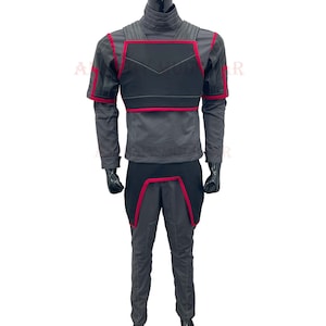 May include: A gray jumpsuit with a black and red chest piece. The jumpsuit has a high collar and long sleeves.