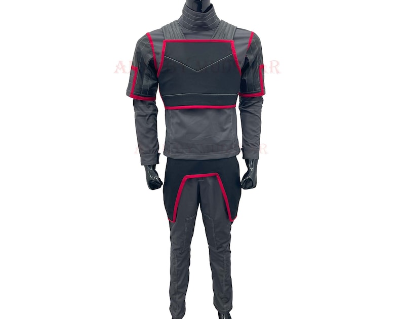 May include: A gray jumpsuit with a black and red chest piece. The jumpsuit has a high collar and long sleeves.