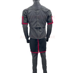 May include: A gray jacket with red accents on the sleeves and a black skirt. The jacket has a zipper closure and a stand-up collar.