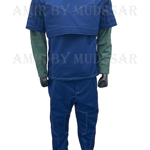 May include: A blue jumpsuit with a dark blue vest and a high collar. The vest has a padded chest piece and shoulder straps. The jumpsuit has a zipper in the front and pockets on the legs.