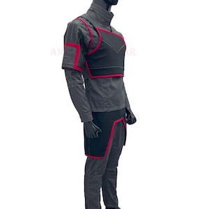 May include: A gray and black costume with red accents. The costume includes a long-sleeved shirt, pants, a chest piece, and a belt.
