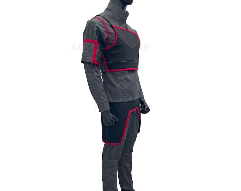 May include: A gray and black costume with red accents. The costume includes a long-sleeved shirt, pants, a chest piece, and a belt.